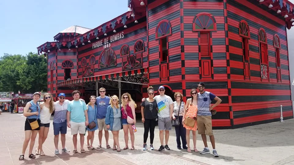 A walking tour group in front of historic architecture in Ponce